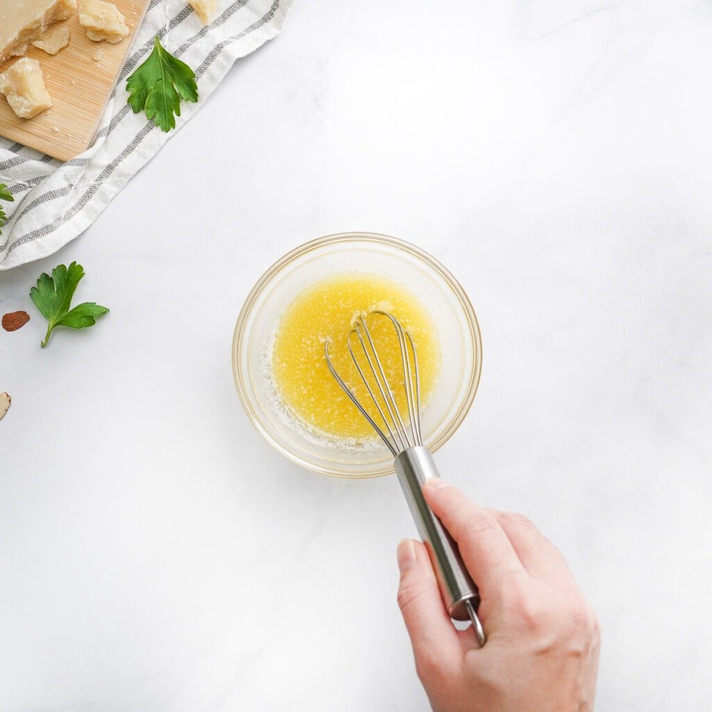 Whisking garlic salt into melted butter for Savory Monkey Bread.