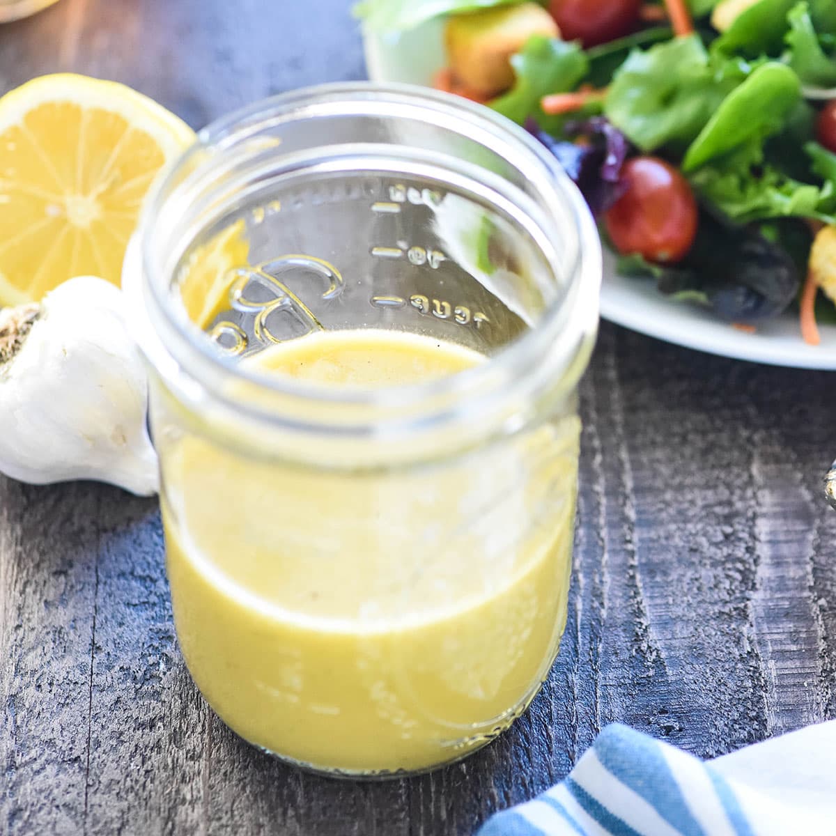 Champagne Vinaigrette in jar with salad.