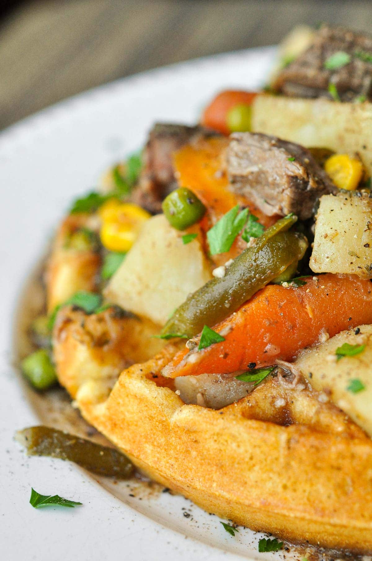 Crock Pot Beef Stew served over a cornbread waffle.