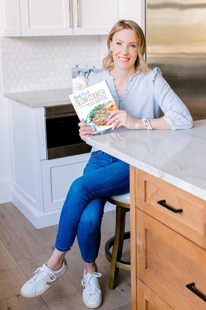 Samantha Skaggs, author of Real Food Slow Cooker Suppers cookbook, holding a copy of the cookbook.