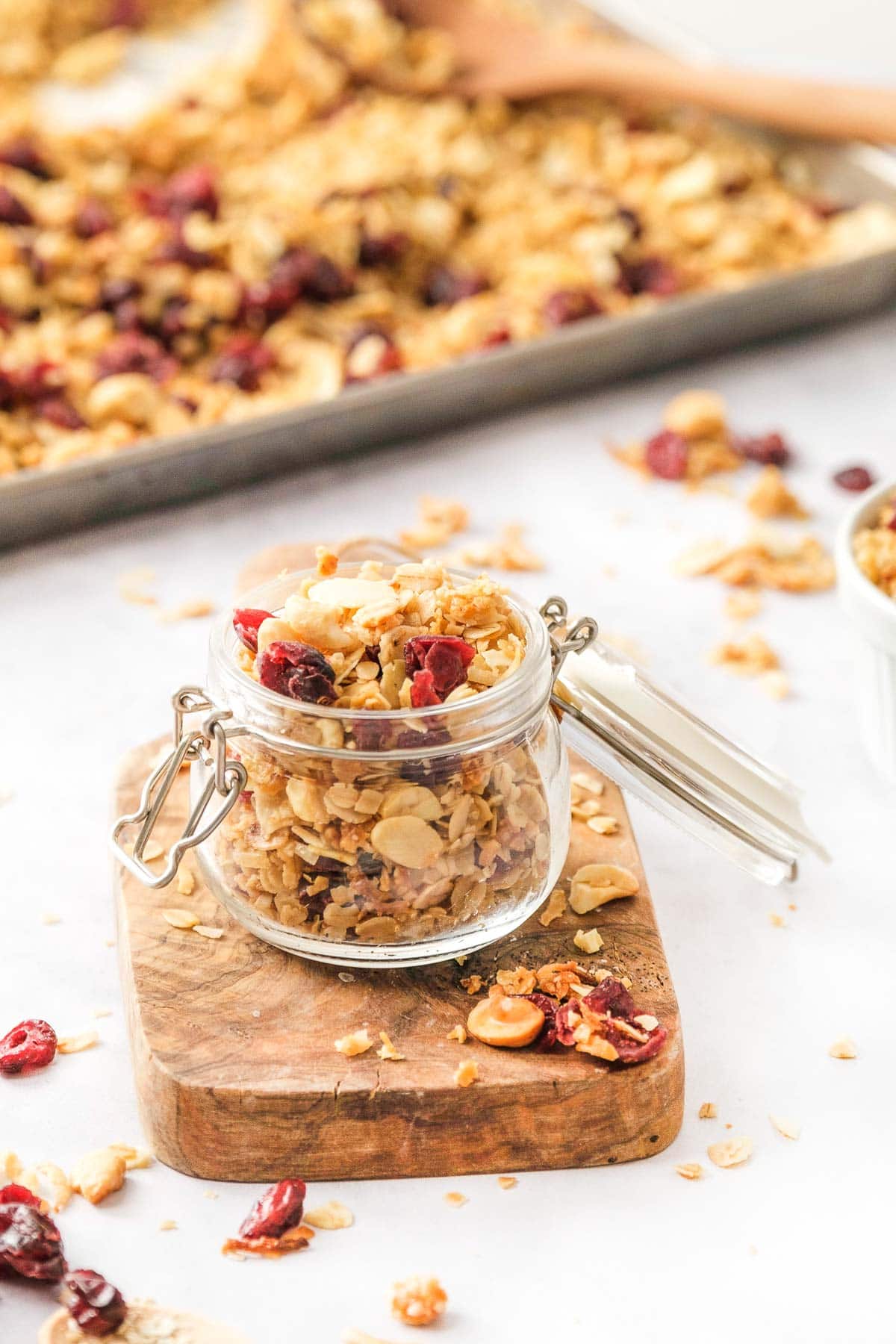 Homemade granola recipe on pan and in jar.