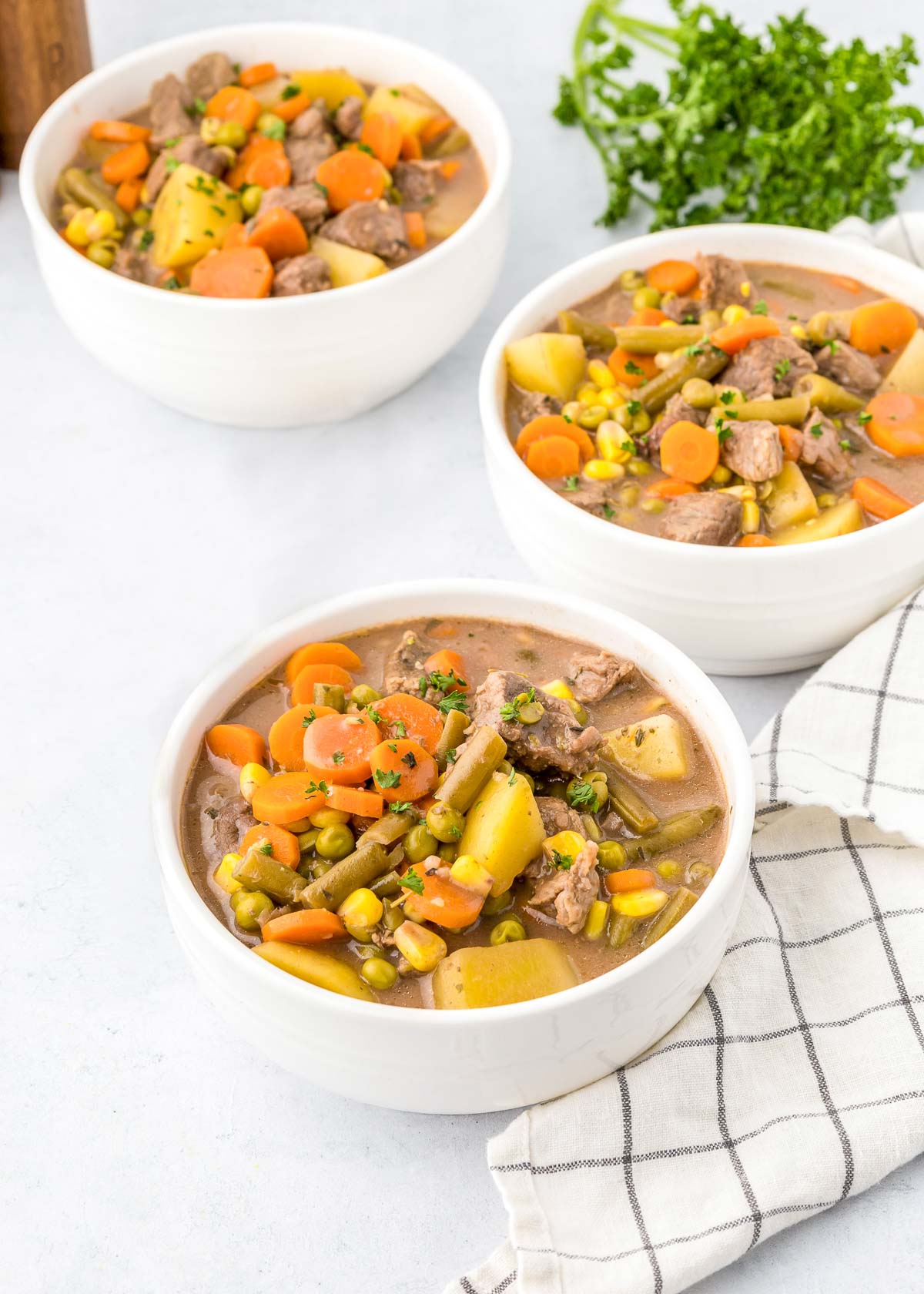 Easy Crock Pot Beef Stew in three white bowls.