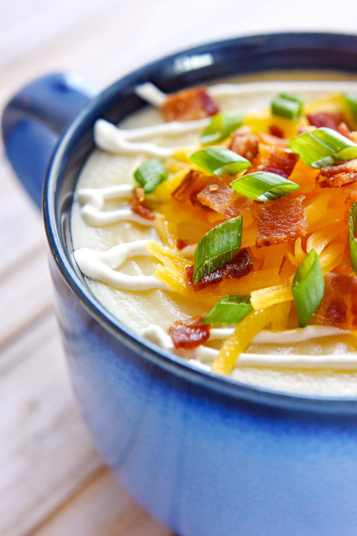 Close-up of garnishes atop Loaded Baked Potato Soup.