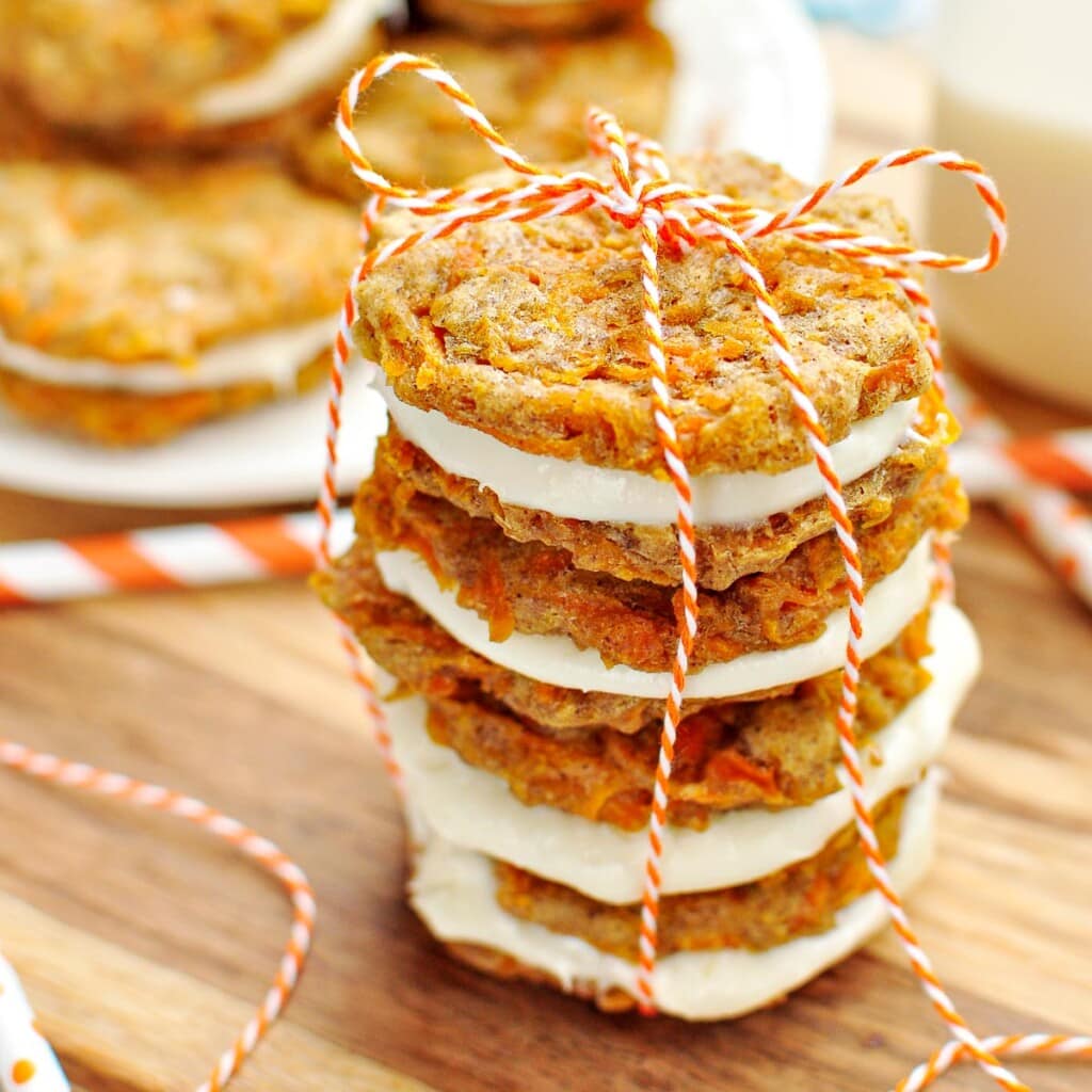 Carrot Cake Cookies with cream cheese filling in a stack.