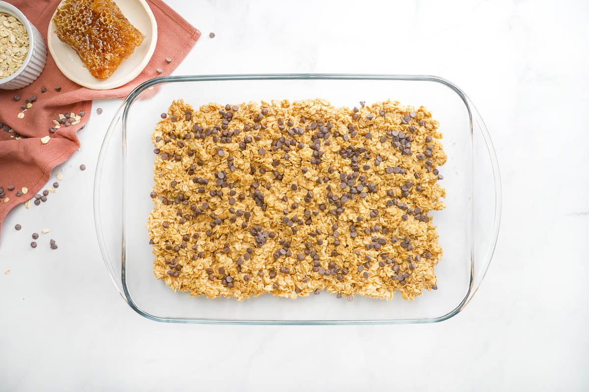 Chewy granola bar recipe pressed into dish.