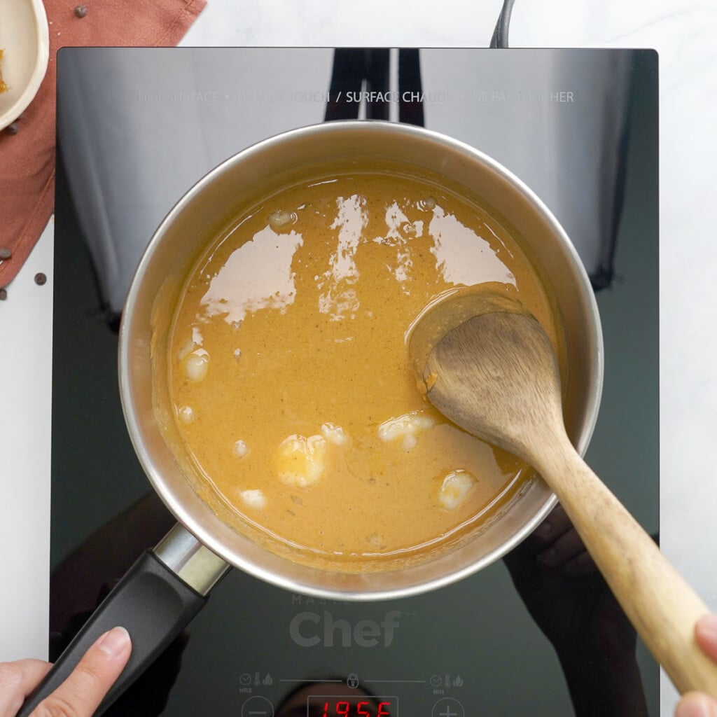 Liquid ingredients combined in pot for chewy granola bar recipe.