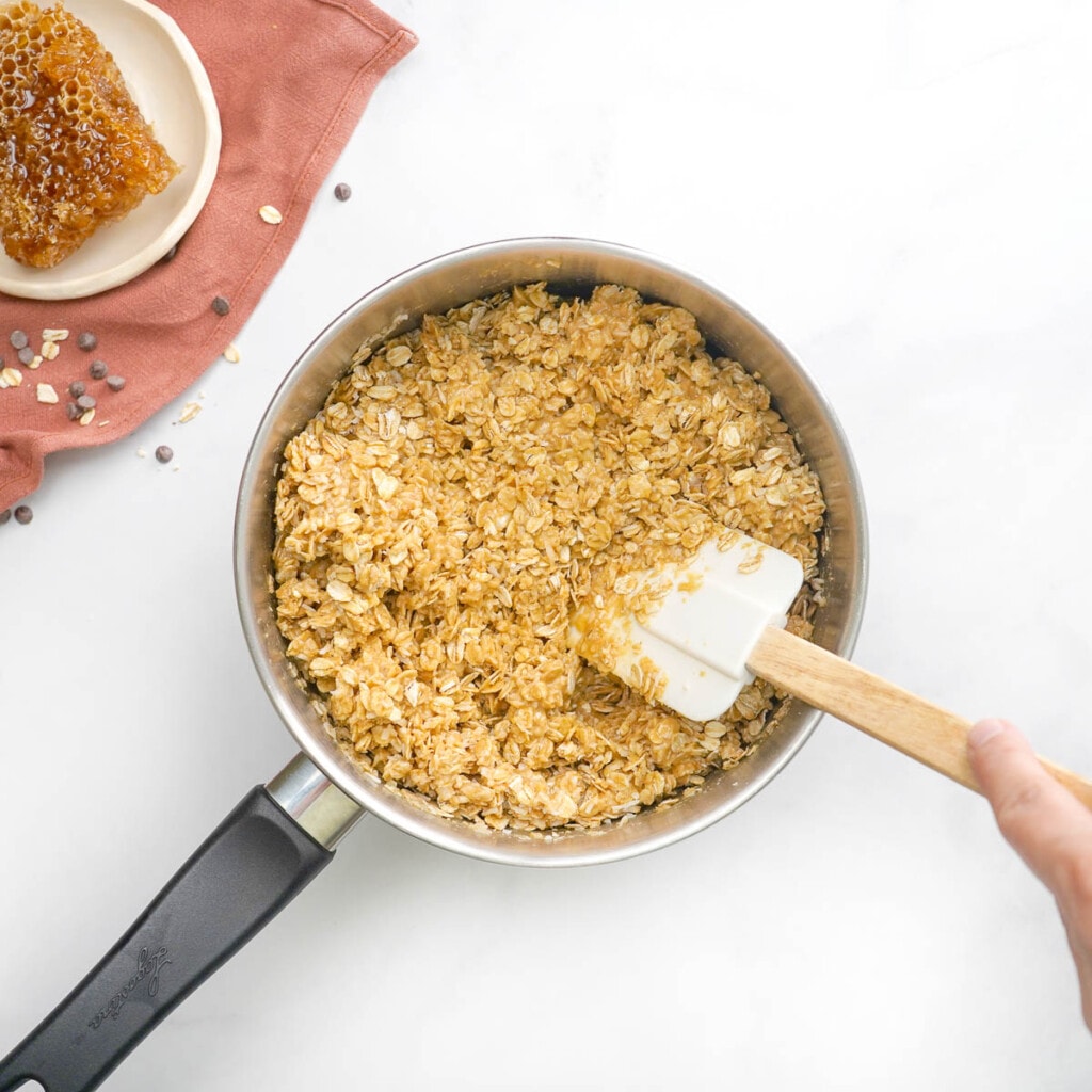 Combining all ingredients for chewy granola bar recipe.