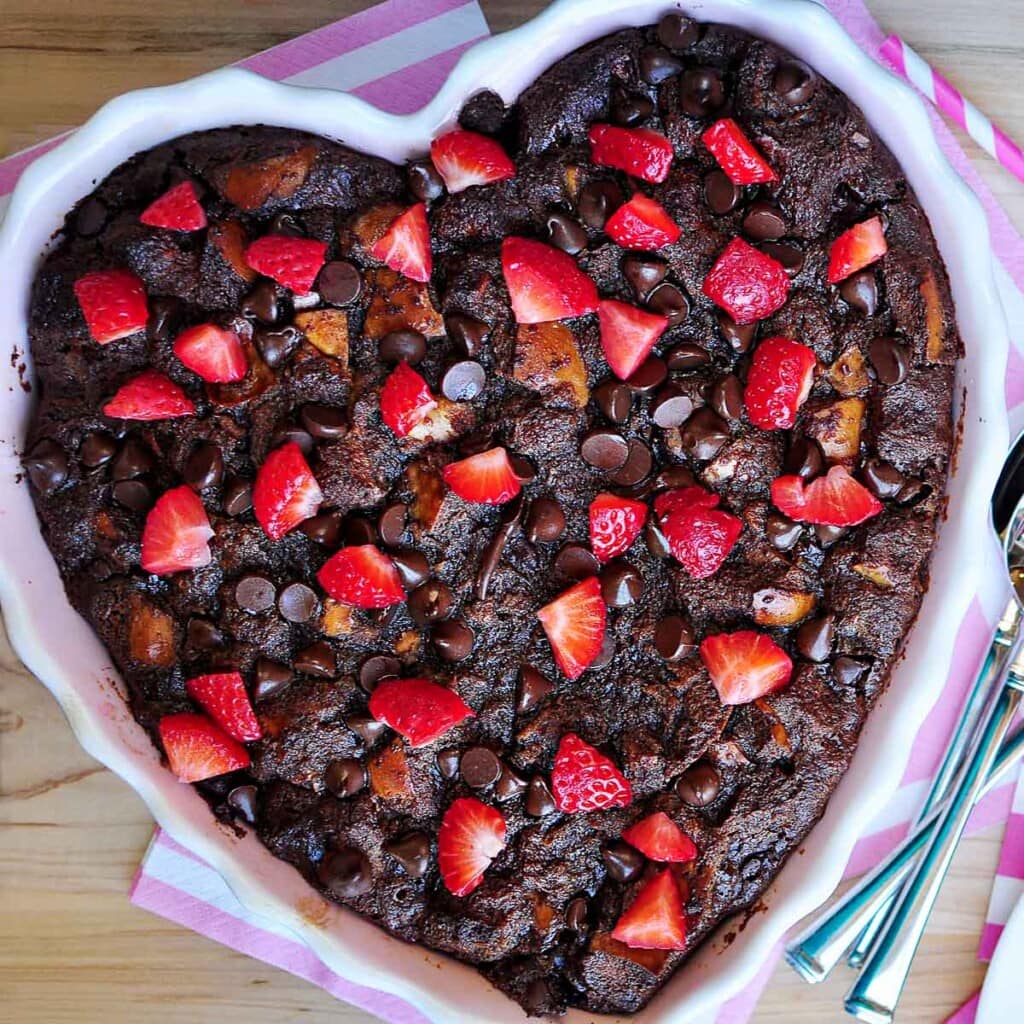 Chocolate Bread Pudding in baking dish with berries.