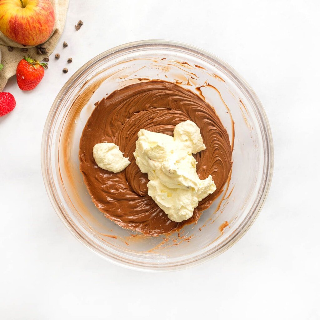 Folding whipped cream into Chocolate Fruit Dip.