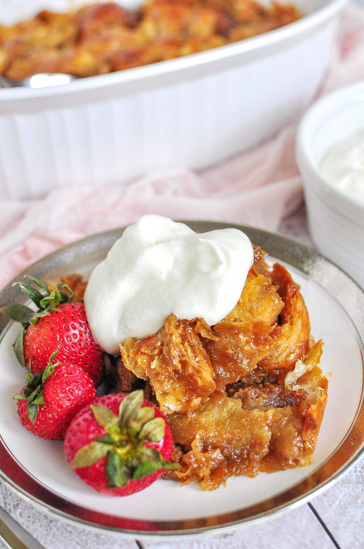 In dish and on plate with whipped cream.