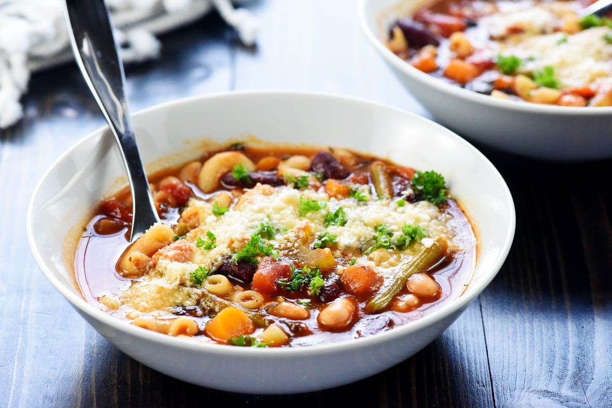 Minestrone Soup in bowls with Parm and parsley.