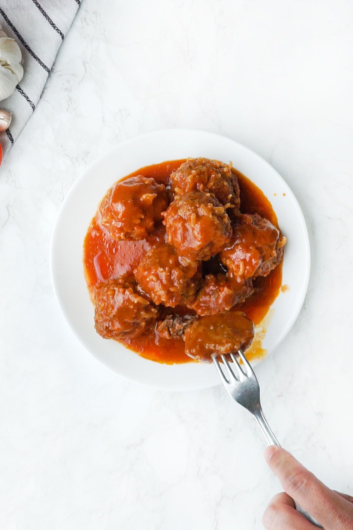 Aerial view of Porcupine Meatballs on plate with fork.