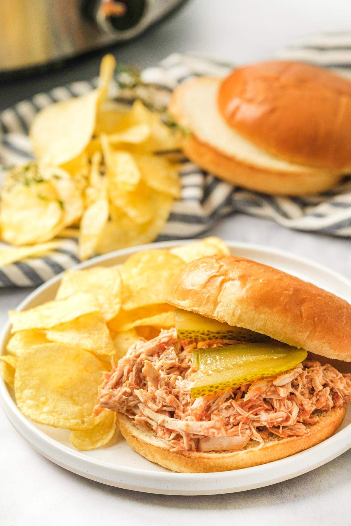 Chicken Sloppy Joes with slow cooker in background.