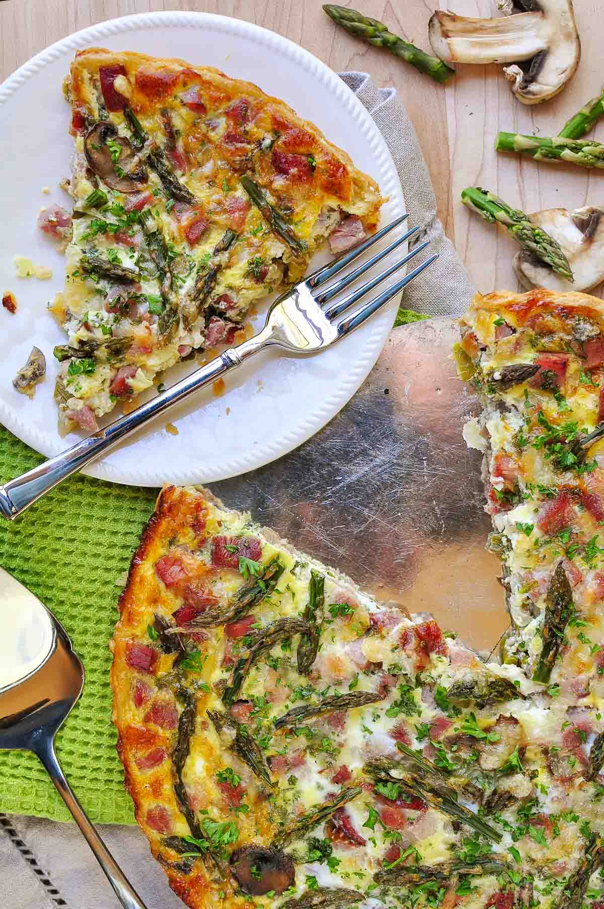 Aerial view of Asparagus Tart on plate and in pan.