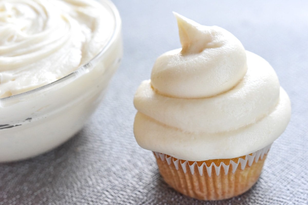 Cream Cheese Frosting on cupcake and in bowl.