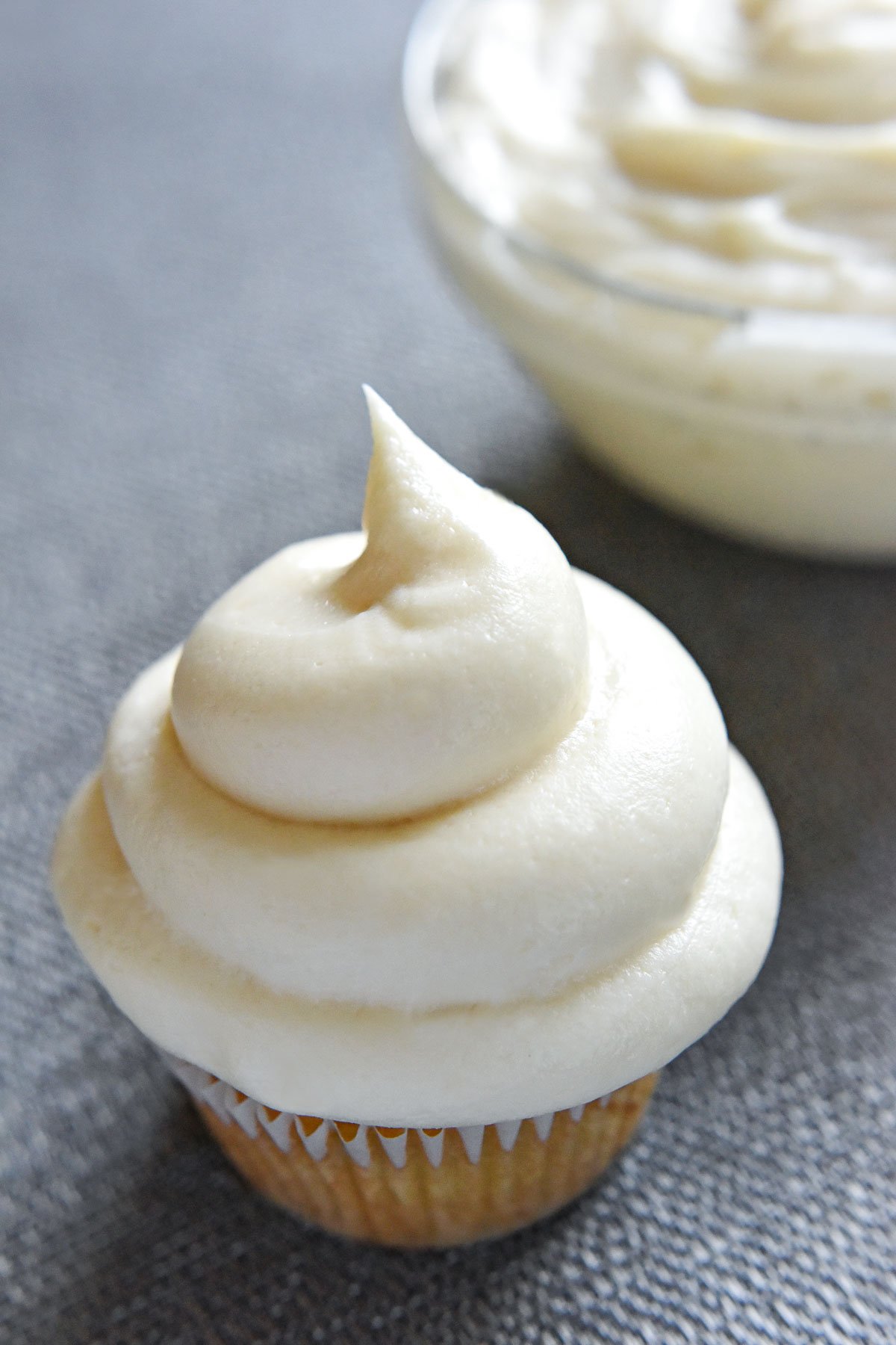 The best Cream Cheese Frosting swirled on a cupcake.