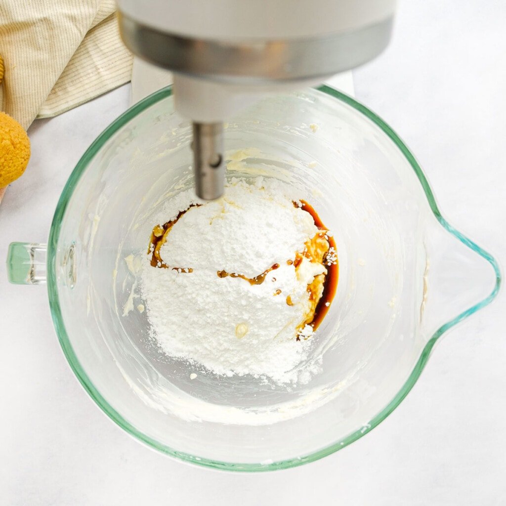 Adding powdered sugar and vanilla to easy cream cheese frosting.