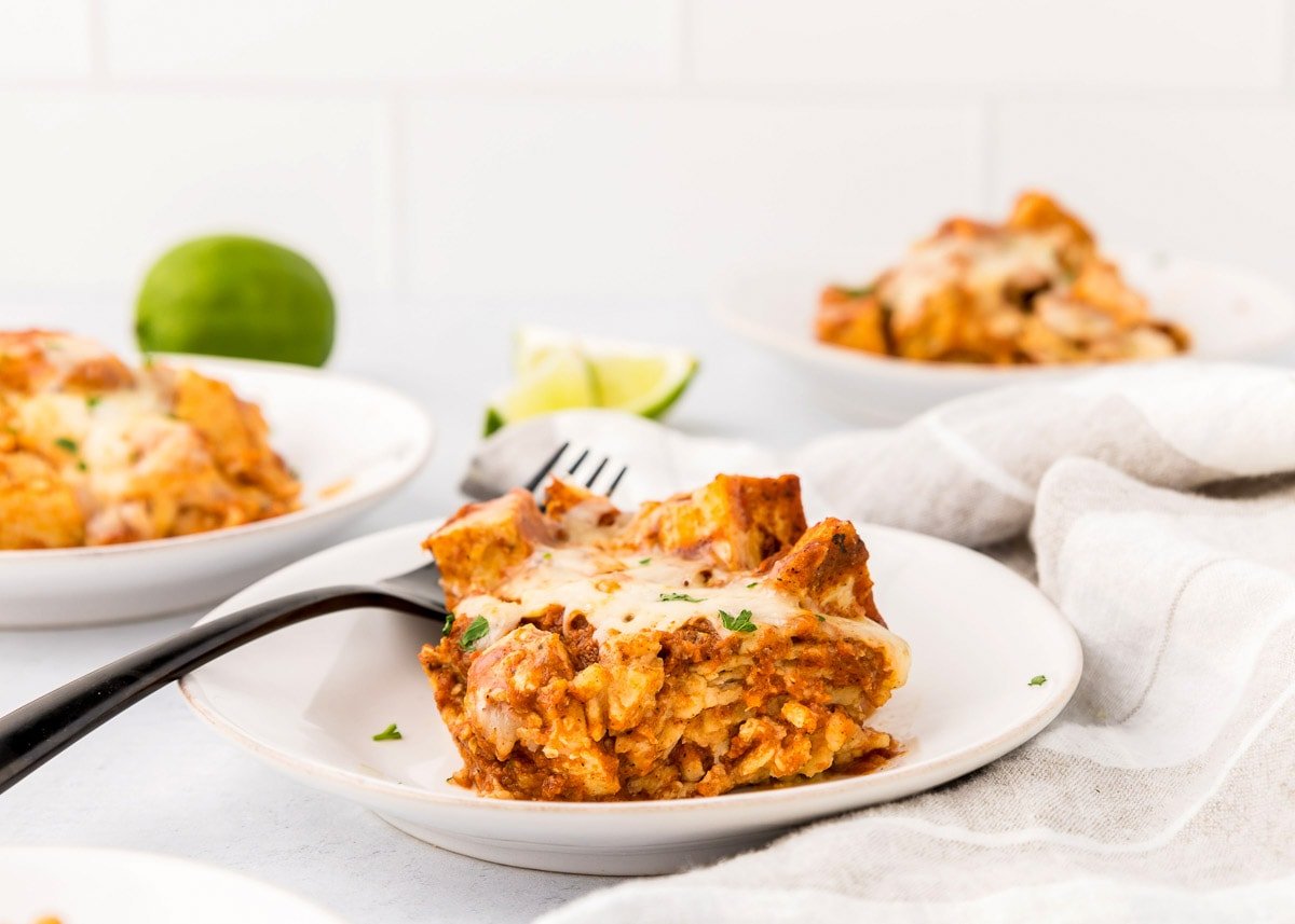 Crock Pot Chicken Enchiladas served with cilantro and lime.