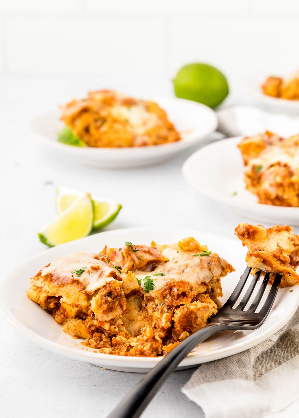 Chicken Enchiladas crock pot recipe with bite on fork.