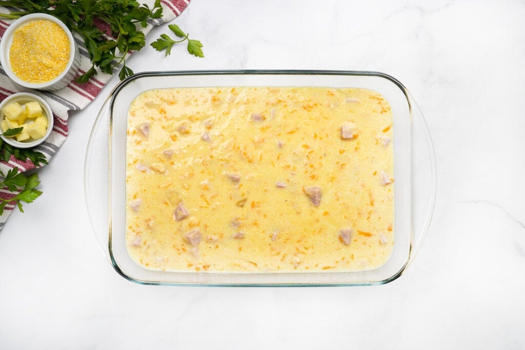 Grits Casserole in baking dish, ready to bake.