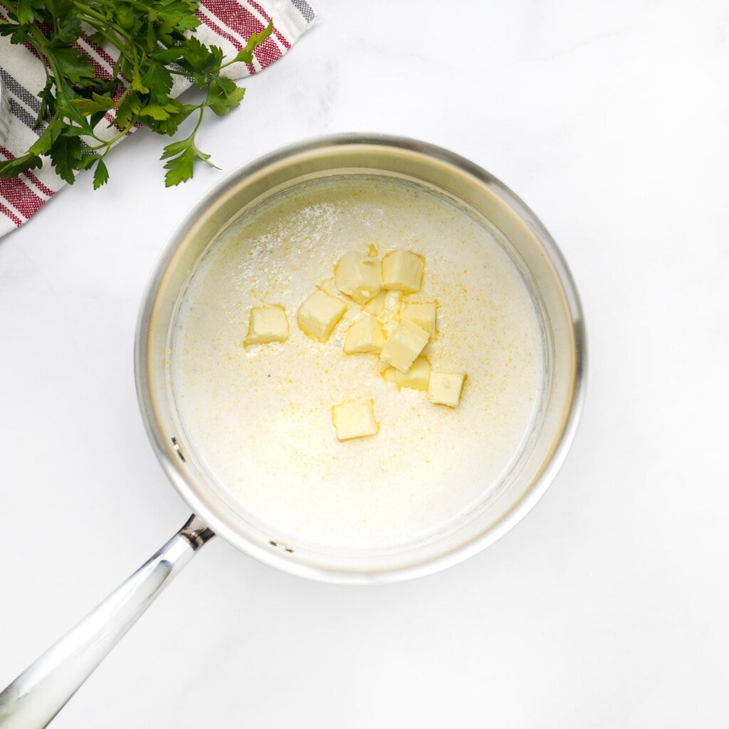 Adding cubed butter to pot.