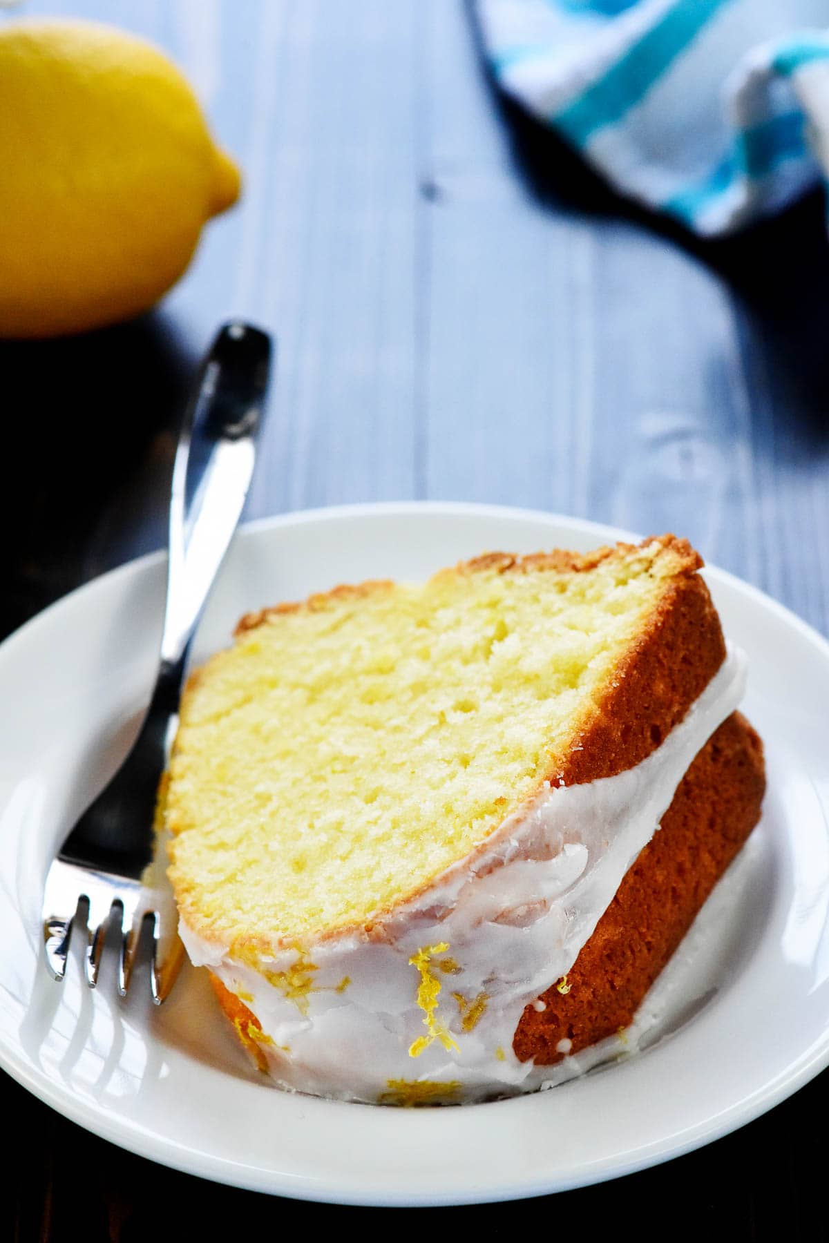 Slice of Lemon Pound Cake recipe on plate with fork.
