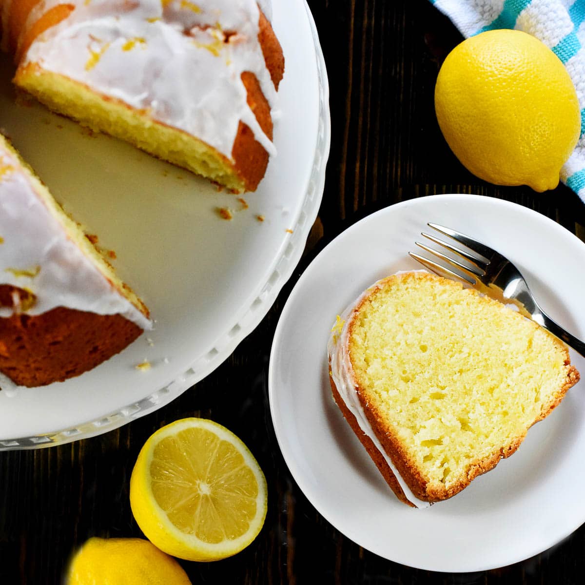 Lemon Pound Cake sliced on cake stand and on plate.