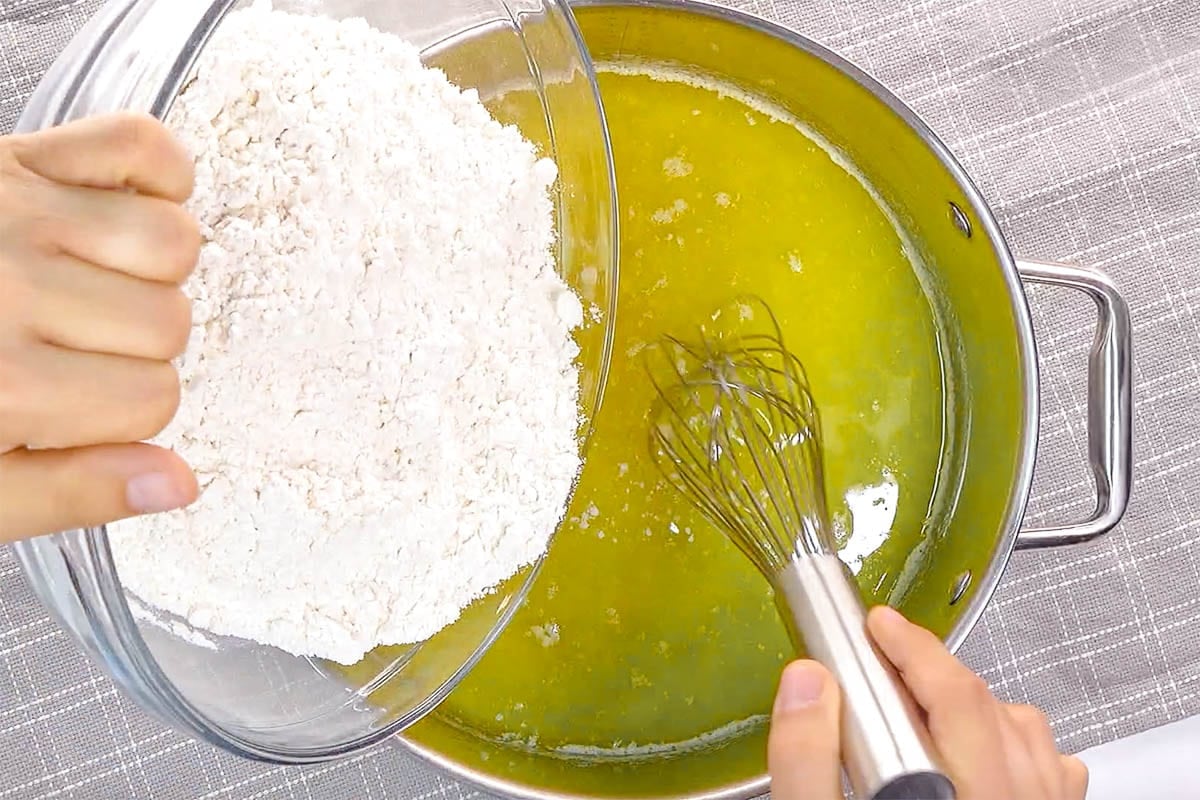 Adding flour to melted butter for easy lemon cake.