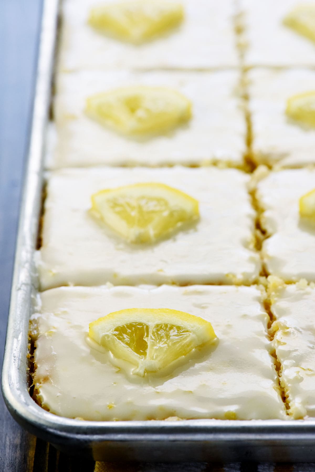 Lemon Sheet Cake sliced in pan.