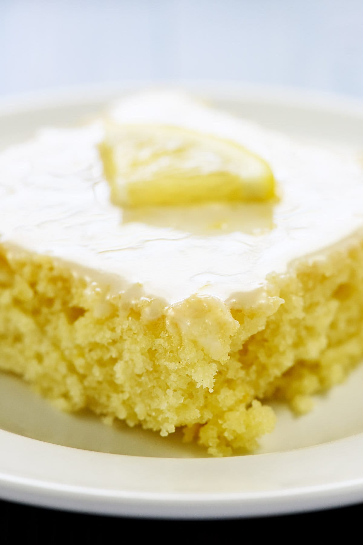 Close-up of slice of Lemon Sheet Cake with lemon glaze.