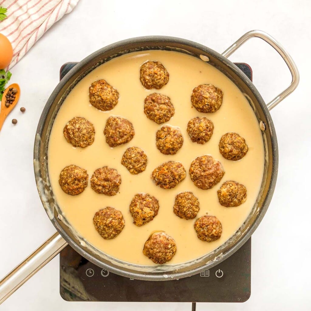 Easy Swedish meatballs in skillet of Swedish meatball sauce.