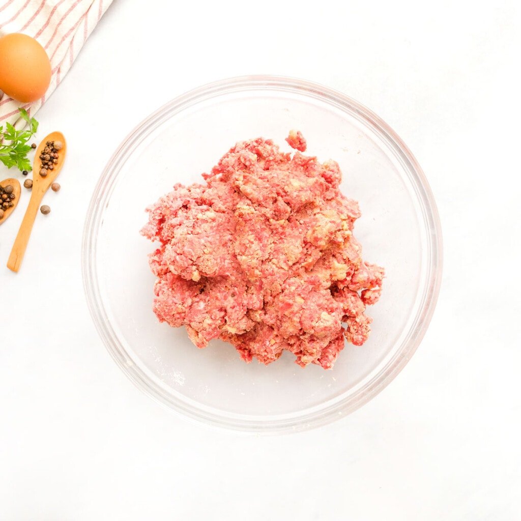 Recipe for Swedish meatballs combined in bowl.