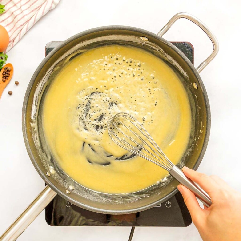 Whisking flour into Swedish meatballs sauce.