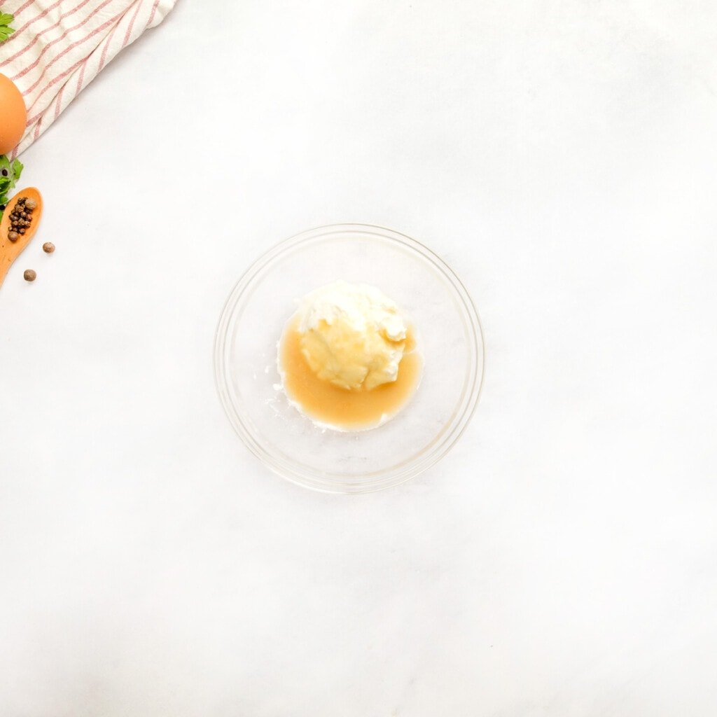 Tempering sour cream in bowl.