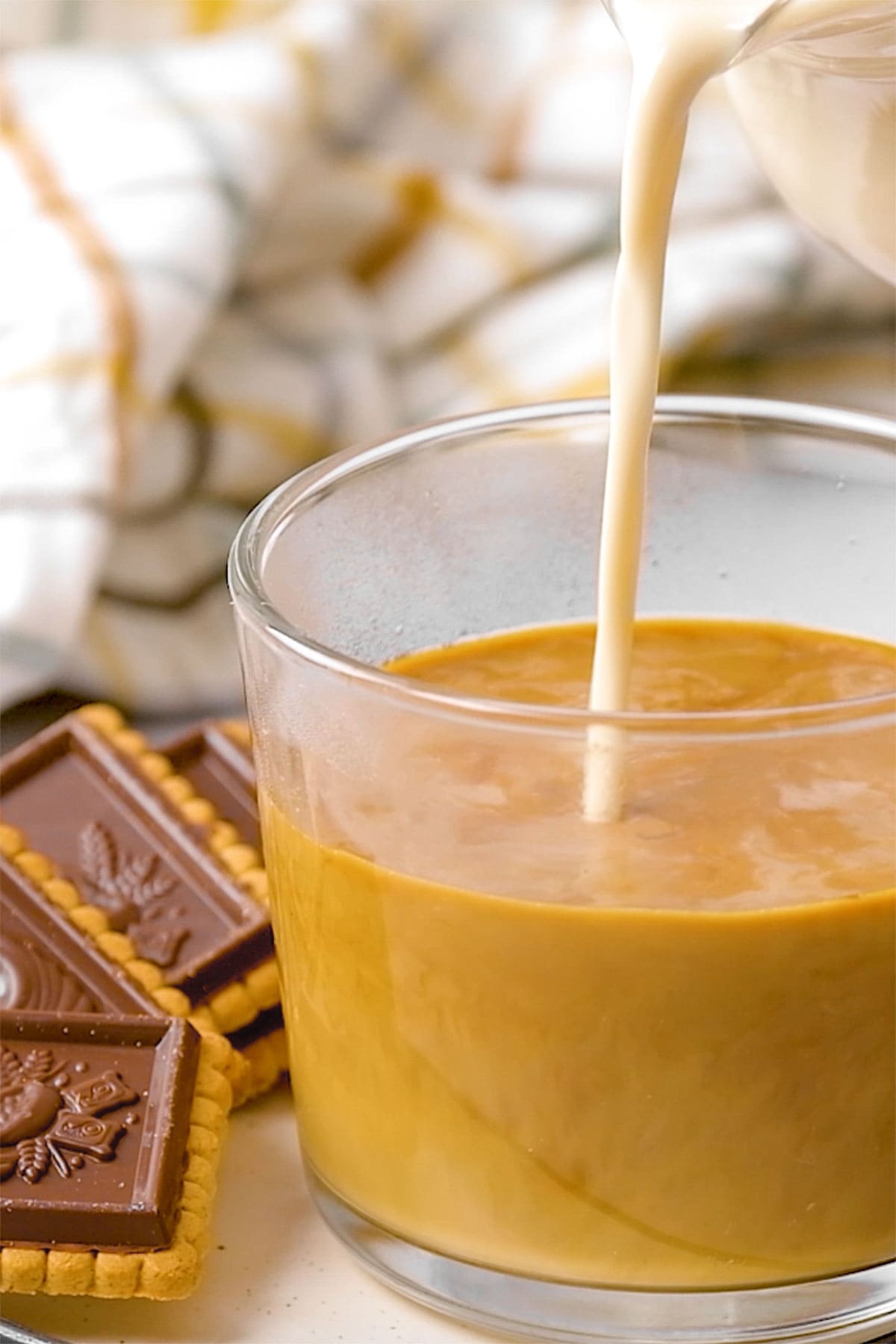 Natural vanilla coffee creamer being poured into coffee.