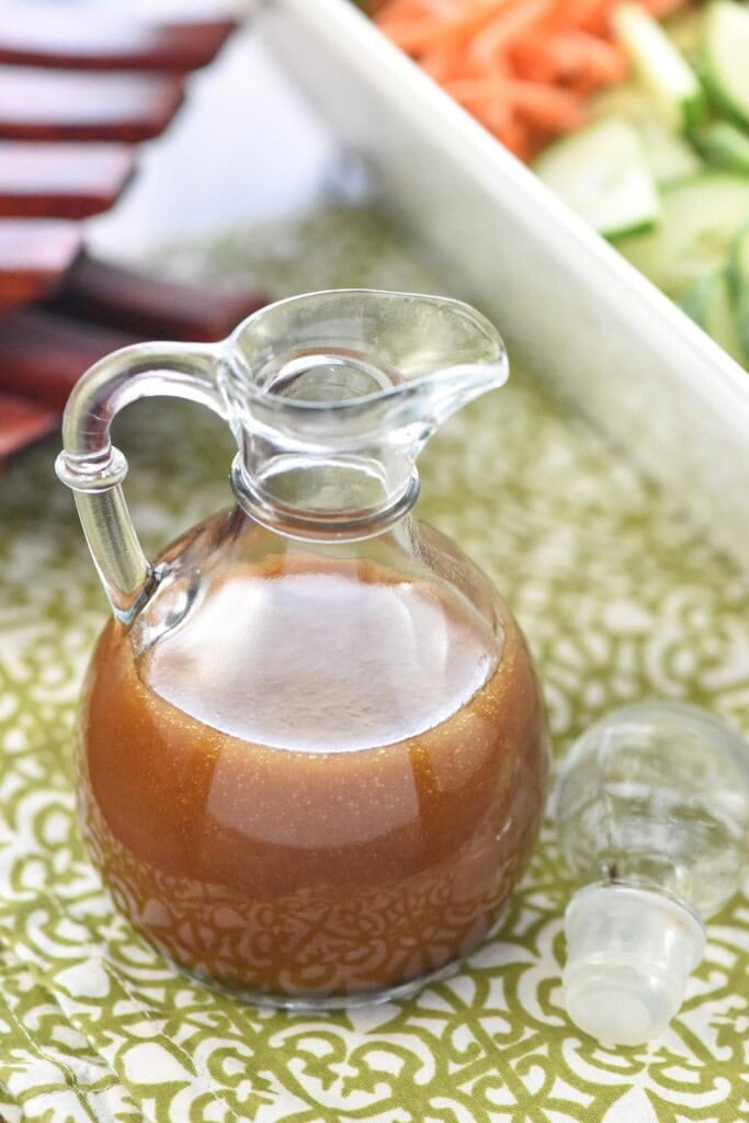 Asian Salad Dressing in glass cruet with lid.