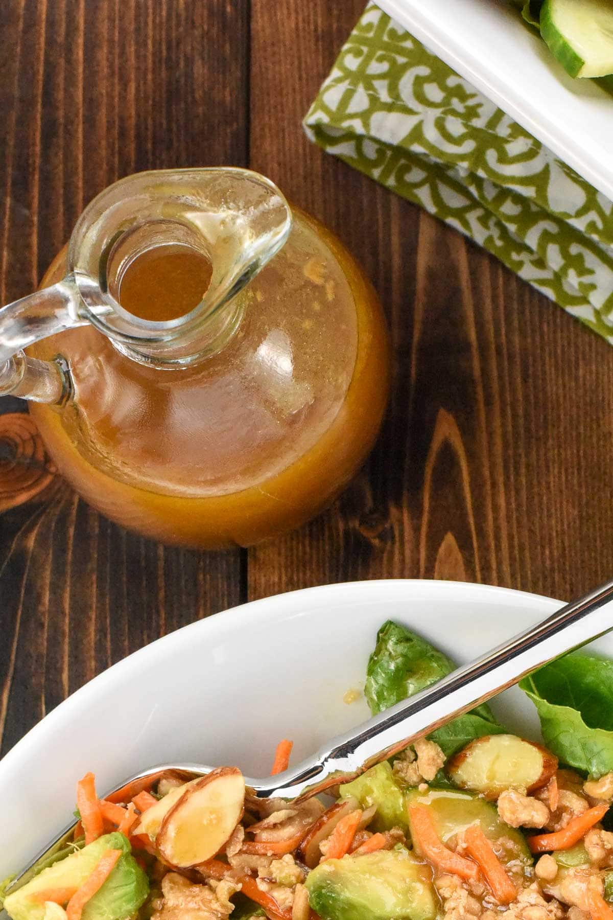 Aerial view of Asian dressing in bottle and on salad.