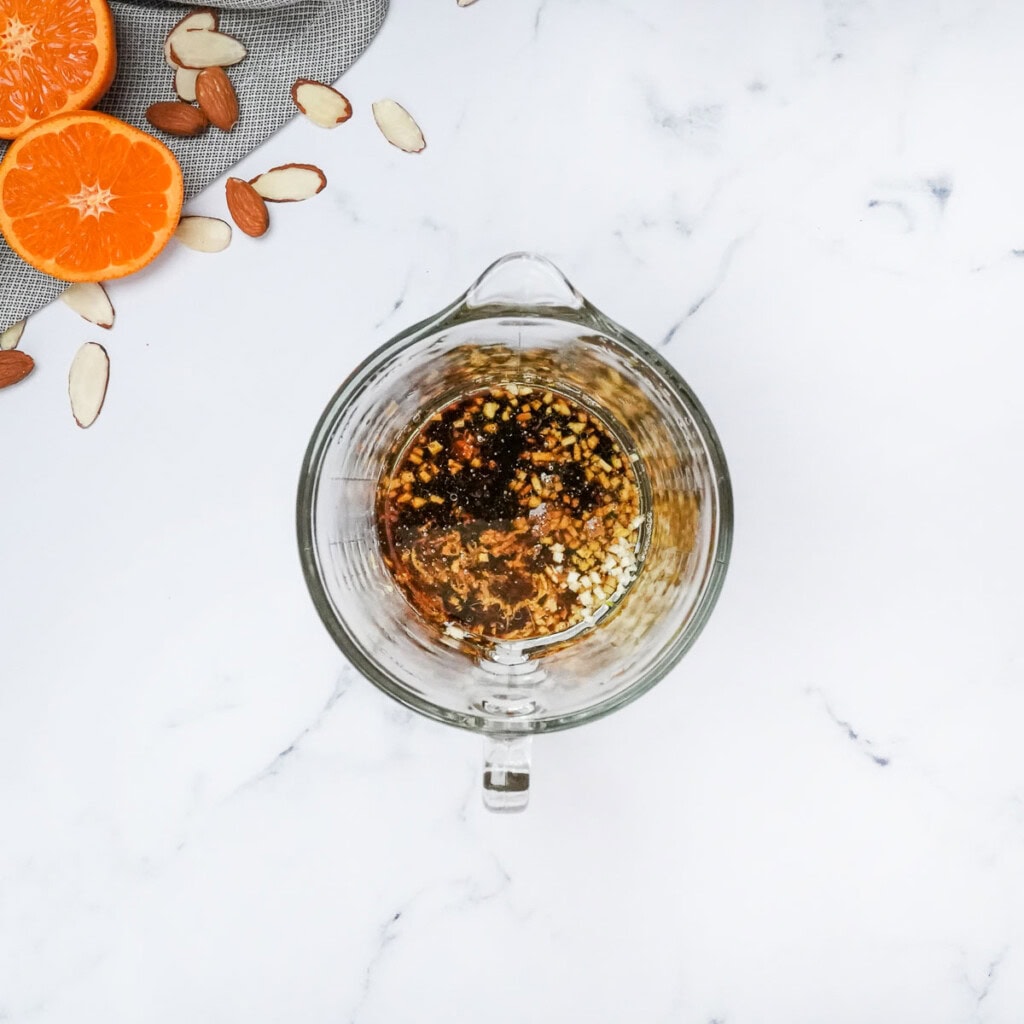 All ingredients in measuring cup for Asian ginger salad dressing.