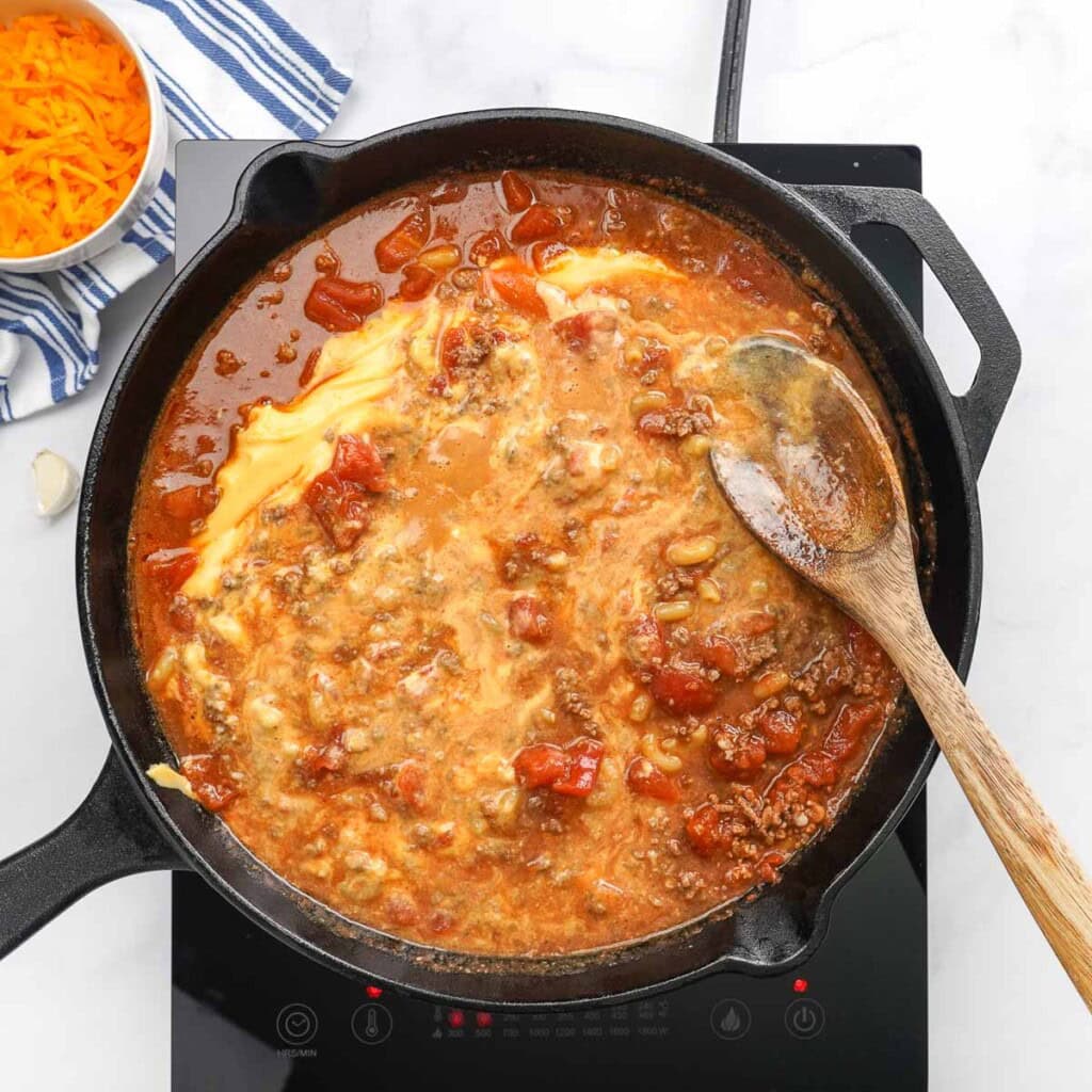 Combining beef mixture and cheese sauce for Homemade Hamburger Helper.