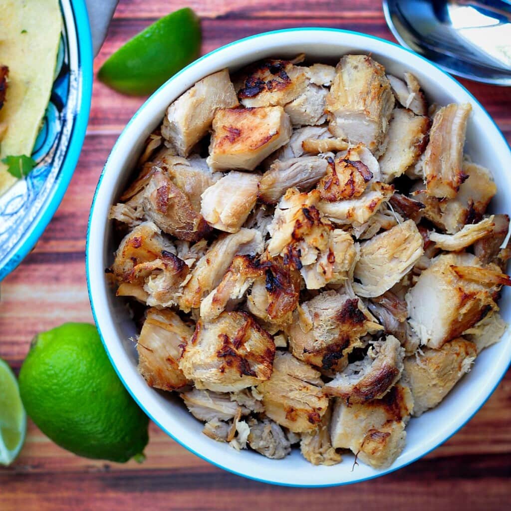 Slow Cooker Carnitas piled in bowl.