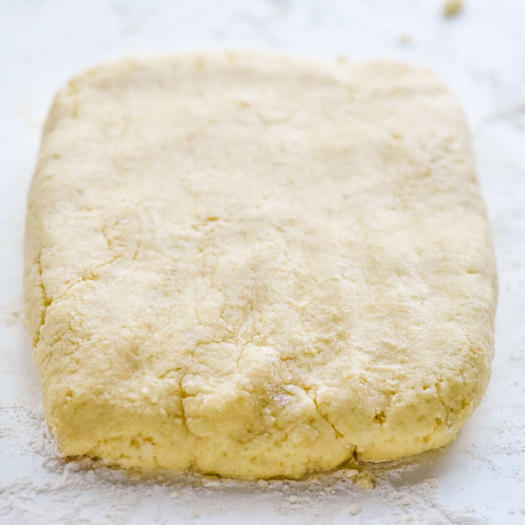 Shortcake recipe pressed into rectangle on floured board.