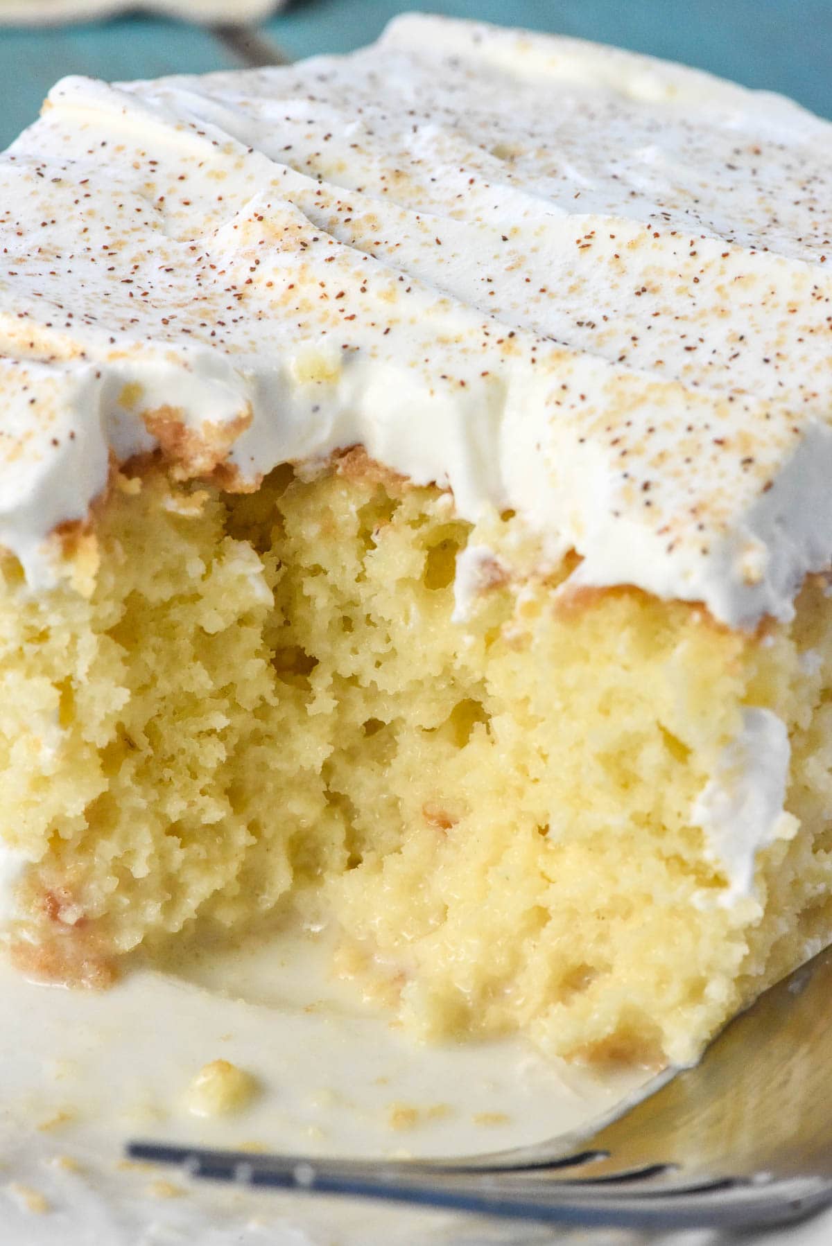 Close-up of easy Tres Leches Cake with bite taken out.