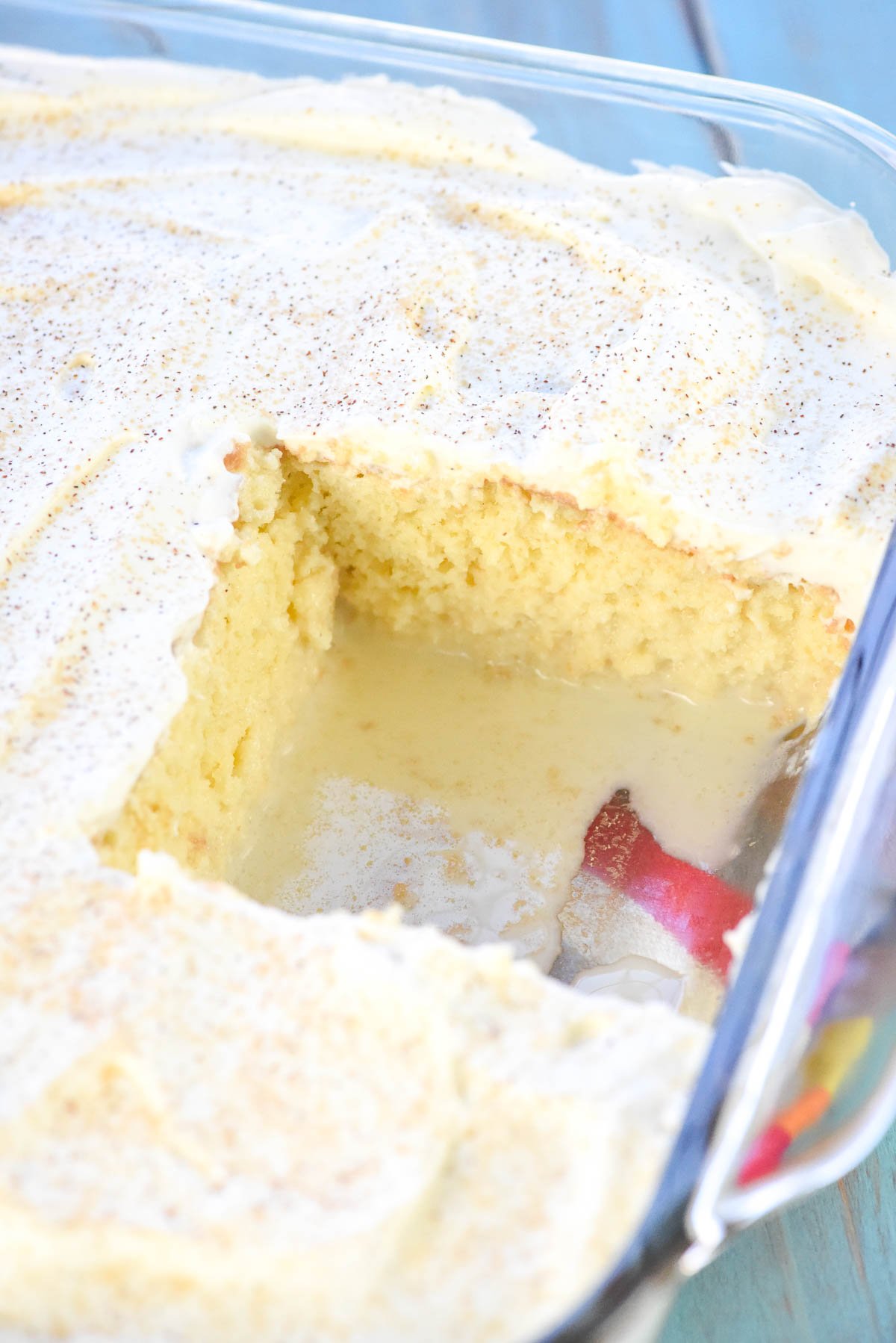 Tres Leche Cake recipe in dish with missing slice.