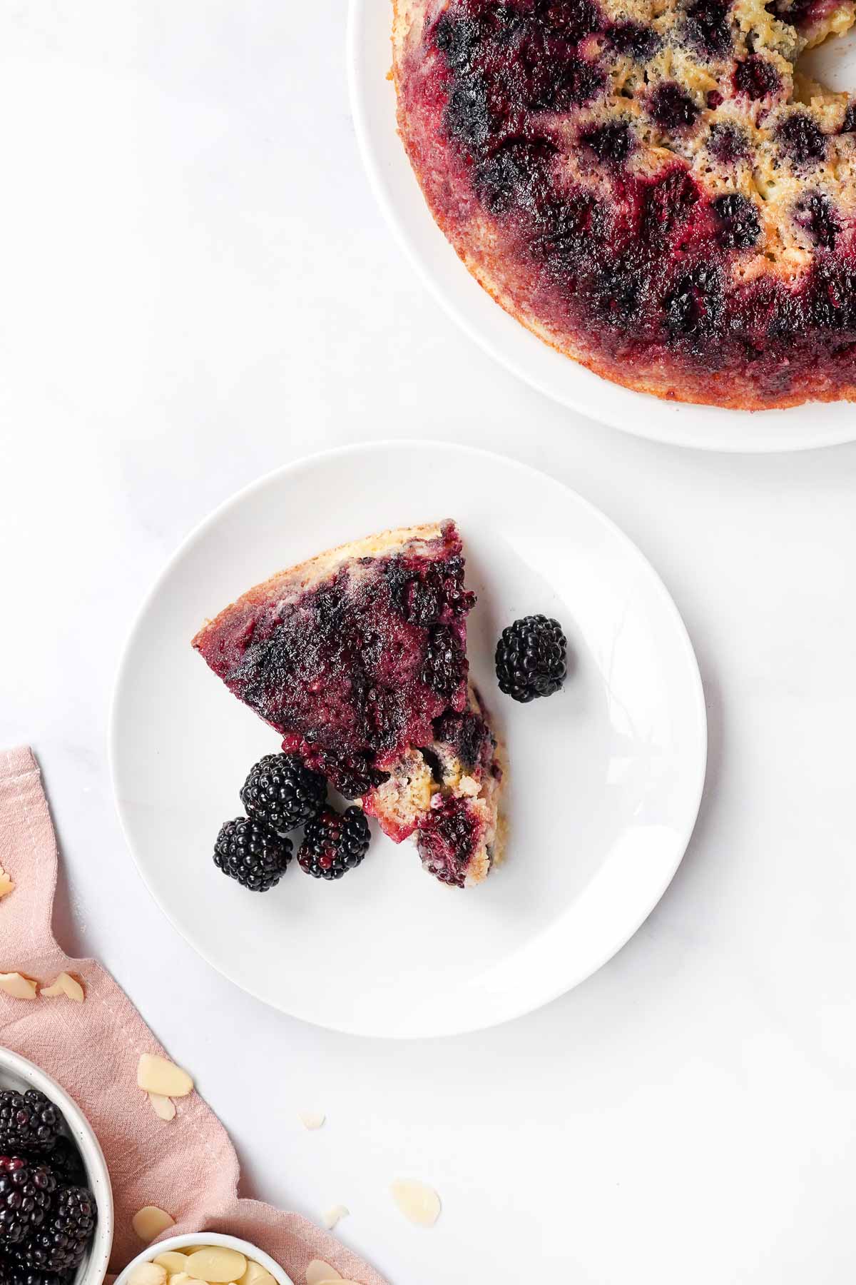 Blackberry Cake on white plate and platter.