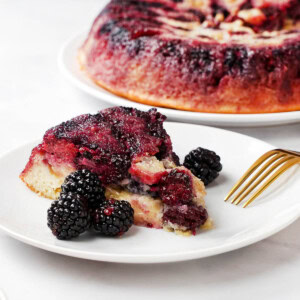 Blackberry Cake served on plate with platter in background.