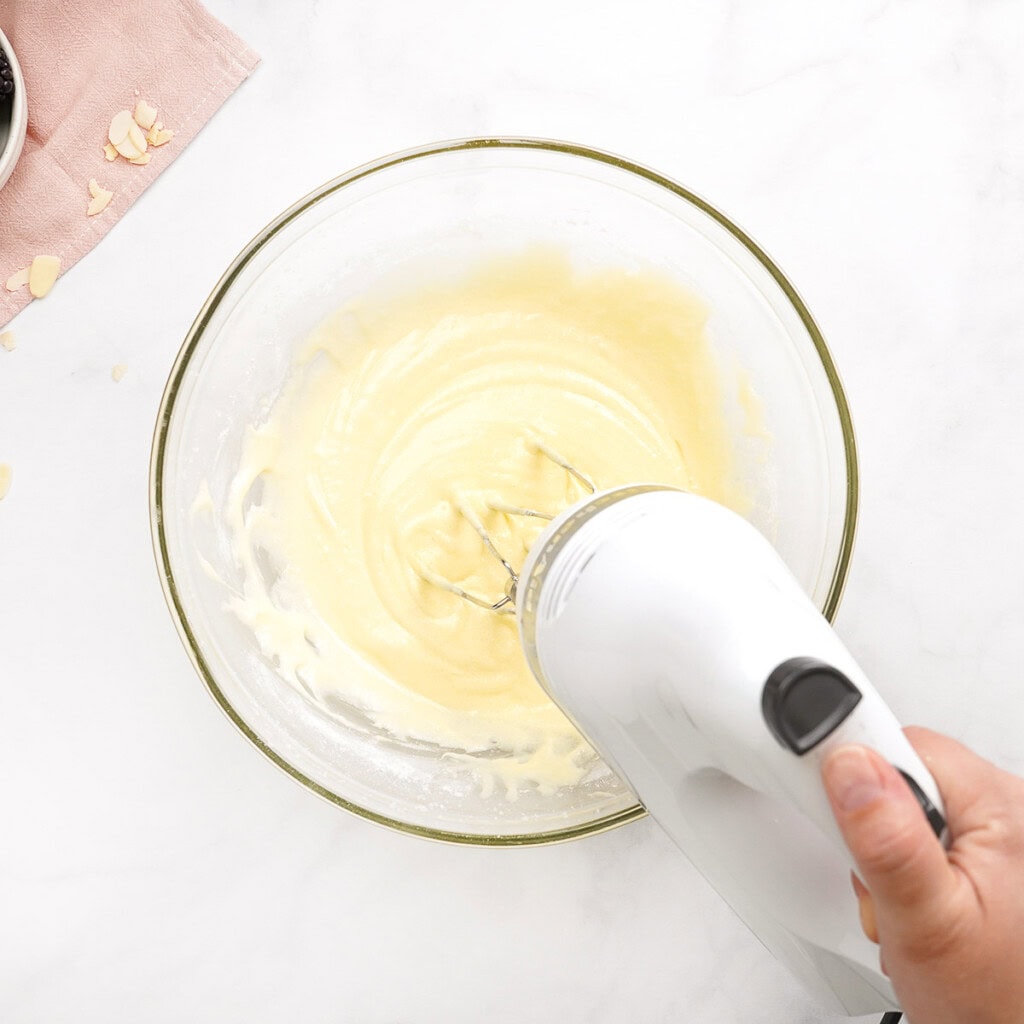 Mixing batter for Blackberry Cake recipe with hand blender.