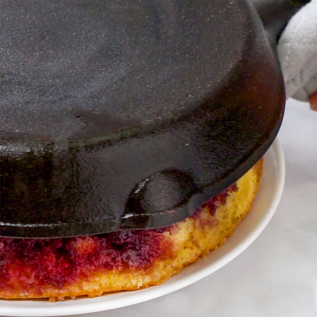 Lifting skillet to reveal Blackberry Cake.