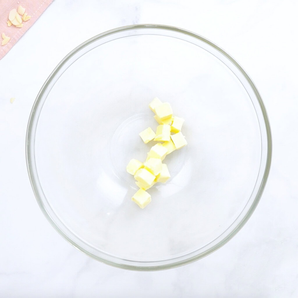 Glass bowl with cubed butter.