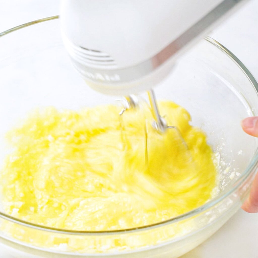 Blending eggs into butter mixture.