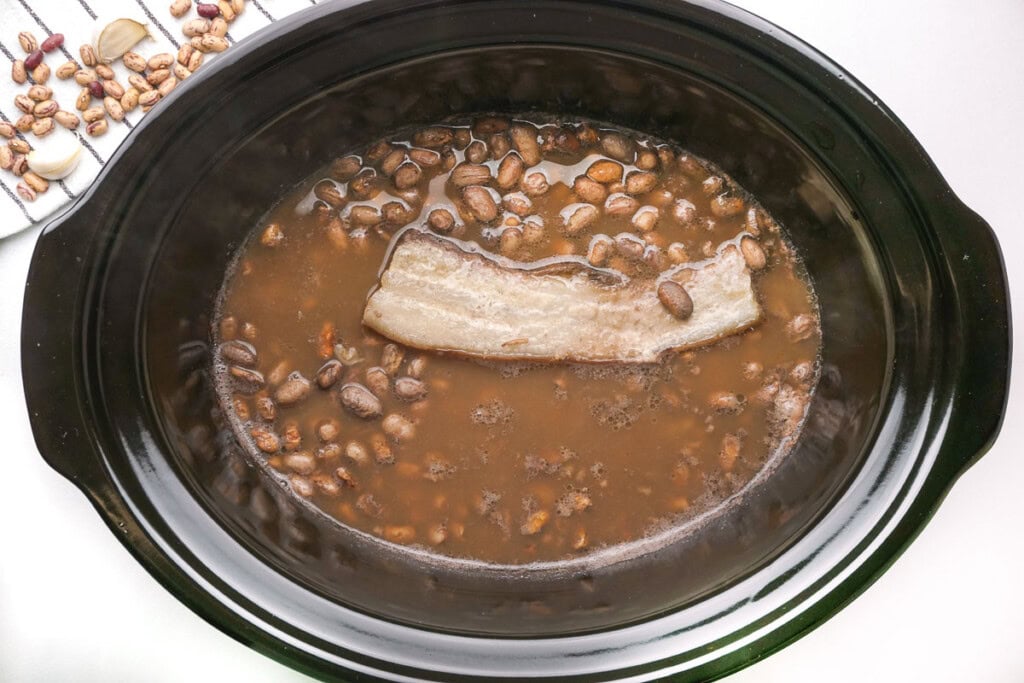 Ranch Style Beans with salt pork in crockpot.